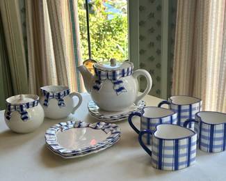Haldon Ribbon Tea Set – Cottage Charm Whimsical ceramic tea service featuring blue-and-white ribbon details, heart-shaped accents, and charming cottage-inspired design. Perfect for tea lovers, collectors of decorative tableware, cottagecore enthusiasts, and those who appreciate unique entertaining pieces. A delightful display set for a breakfast room, tea party, or vintage-inspired kitchen.