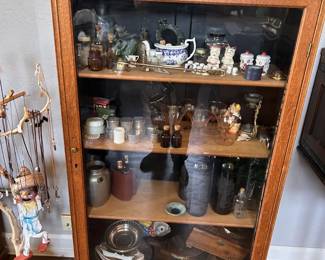 apothecary-style bottles, ceramics, glassware, teapots, figurines, jars, and assorted small curiosities.