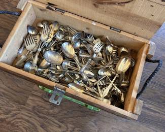 mixed vintage flatware, silverplate-style utensils, serving pieces, spoons, and forks.