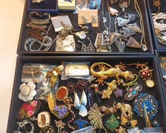 A diverse selection of animals and a shark tooth necklace are a couple of the highlights in these trays