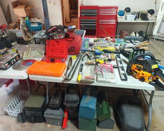 Empty toolboxes and various power tools. Chainsaw