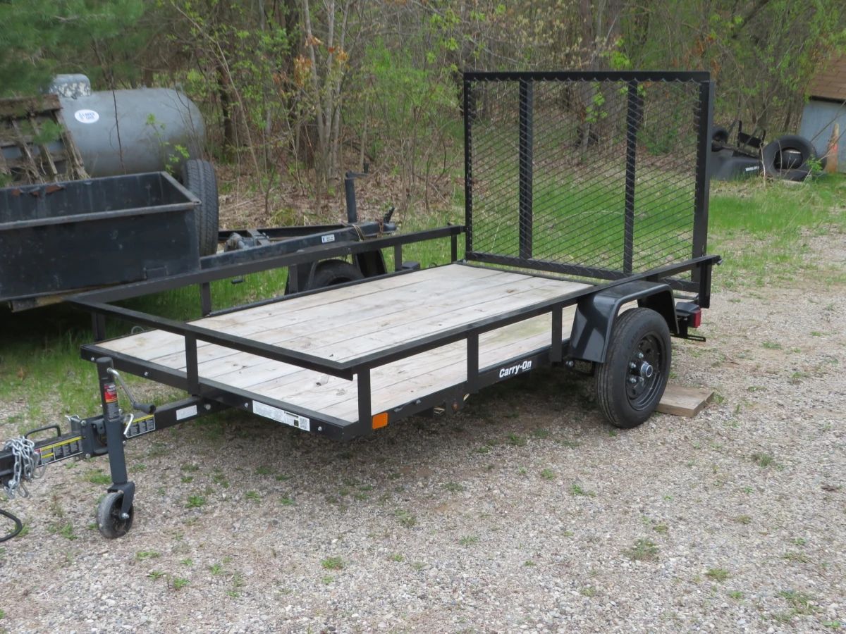 Lot 11. 8' x 5' "Carry On" utility trailer in excellent condition. Lights, 2-inch ball. There is no title, but there is a permanent license.