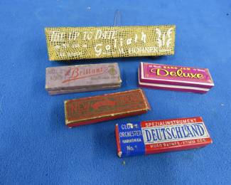 Lot 286. Five empty harmonica boxes: 8"Hohner "The Up To Date Goliath" box with metal hinges in excellent condition. 4 1/4" Band Jam Deluxe. 4 1/4" Elfland New Friend". 4 1/2" Hugo Rauner Deutschland. 4" Rolz Brilliant