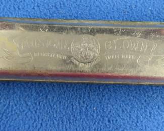 Lot 282. F. A. Bohm The Musical Clown 64-reed double hole tremolo harmonica in the key of F with poor sound.