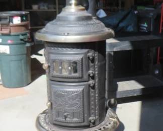 Lot 22. No. 28 Silver Oak cast-iron parlor stove made by the Co-op Stove Co. in Cleveland, Ohio. Dated 1893. Appears to be complete and ready to use. Base is 23" x 21". Height to the top of the finial is 61 inches. Bring help to load.