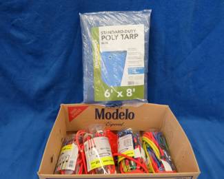 Lot 313. 6' x 8' poly tarp and jars of bungee straps