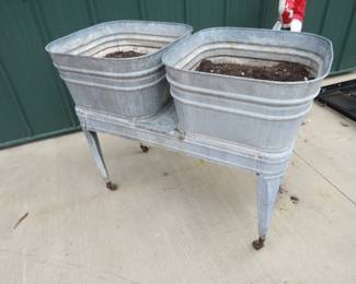Lot 138. Two vintage washtubs on a double washtub stand