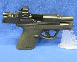Lot 418. Smith & Wesson M&P 9 Shield Plus Bugout Edition S/N: JNX0666; 9mm pistol with a Holosun HS407K X2 Micro Red Dot, five magazines, bug out bag, and original box. Permit Required.
