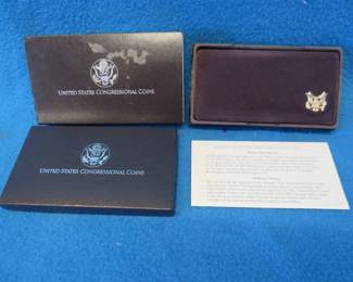 Lot 384. 1989 US Congressional coin set. Includes a 90% silver proof dollar coin and a clad proof half dollar.