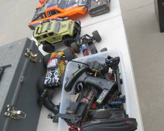 Lot 375. Toolbox full of Traxxas components for remote control cars. Unmatching remote control car components. Seller said there is a controller for the Army vehicle. Untested.