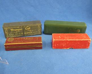 Lot 354. Four empty harmonica boxes: 6 3/4" Hohner Trumpet Call box in excellent condition. 5 1/2" Thorens Professional box No. 10. 7 1/2" Hohner Chromonica 270 plastic box. 5m3/4" two-piece Rubberset box