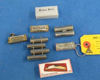 Lot 414. Harmonica smalls: Violin tuner. PeeWee harmonica. Medal Lucky Miniature four-hole harmonica. Hohner four-hole diatonic harmonica. A box of matches Das Mundharmonikacenter. Empty Erwin ball box.