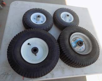 Lot 300. Two lawnmower tires with wheels and two dolly tires with wheels