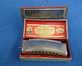 Lot 355. F. A. Bohm Liliput 8-hole harmonica and box. Sounds fair. Herb Shriner's "Hoosier Boy" 10-hole diatonic harmonica in the key of C. Sounds great.