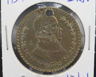 Lot 478. 1957 silver Mexican Peso with a hole drilled in it