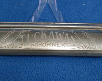 Lot 358. M. Hohner Tuckaway 64-hole tremolo harmonica in the key of C. Sounds great. Tuckaway feature works fine. Minimum bid $20. Opening and closing feature works fine.