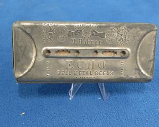 Lot 359. Hohner "ECHO" double-sided tremolo harmonica with 32 holes and bell metal reeds on each side. Draw notes do not sound good.