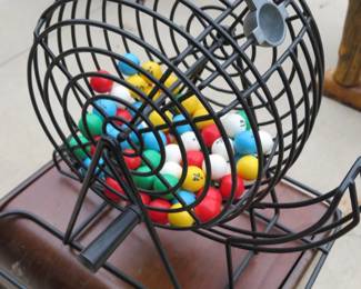 Lot 153. Bingo cage and balls on a sewing cabinet that contains bingo cards and accessories