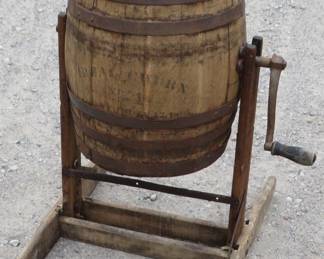 Lot 141. Antique rotating #1 Ideal Butter Churn on a stand. Dated 1898. The top and bottom have been repaired or replaced. The barrel is approx. 18 inches tall.
