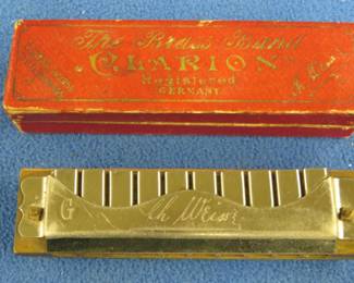 Lot 413. Ch. Weiss The Brass Band Clarion 20-hole tremolo harmonica in the key of G in the box. Sounds great. The box is in VGC. Minimum bid $20.