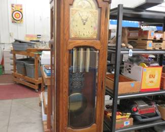 Lot 393. Howard Miller grandfather clock. Model 610-208. German movement with a moon phase dial. 85" x 24" x 14".