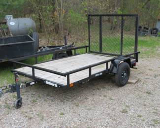 Lot 11. 8' x 5' "Carry On" utility trailer in excellent condition. Lights, 2-inch ball. There is no title, but there is a permanent license.