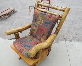 Lot 126. Log gliding rocker. The chair is in excellent condition, but the fabric needs cleaning