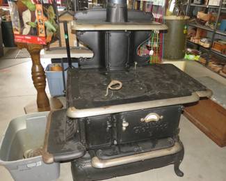 Lot 346. Antique Glenwood No. 508E wood cookstove. We are unsure if it is in usable condition. It was on display in the consignor's home. It includes some extra burner plates and handles. Very heavy, bring help to load.