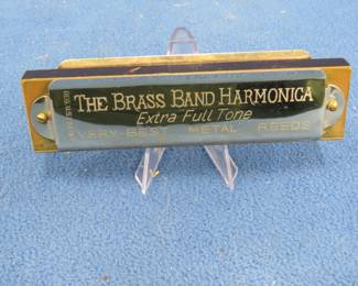 Lot 411. Weiss The Brass Band harmonica in the key of G in a two-piece box. Sounds great. The box is in good condition. Minimum bid $20.