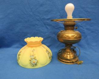 Lot 58. An electrified kerosene lamp with a glass shade. There is a very tight hairline crack in the shade.