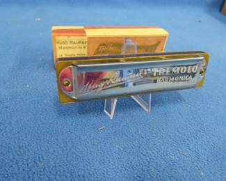 Lot 284. Schlossmeinel-Hugo Rauner's Hugo Rauner's tremolo harmonica and box with 14-double holes and 28 reeds in the key of G. The harmonica is in excellent condition. Sounds great. The box is in fair condition