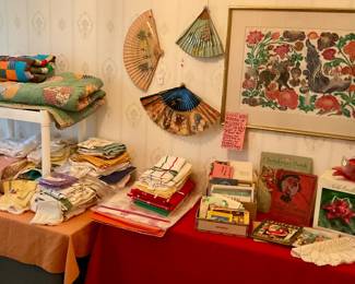 Quilts and linens, kitchen towels, folding fans some hand painted