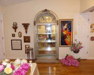 Henredon arched curio cabinet in champagne finish, Tarkay framed artwork, decorative wall hangings