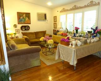 Sofa & loveseat, glass top brass base coffee table, lots of bric-a-brac, framed art, decorative wall hangings