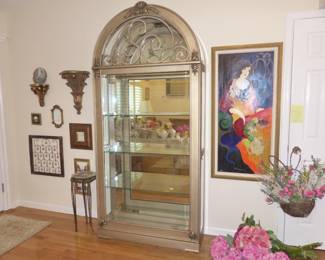 Henredon arched curio cabinet in champagne finish, Tarkay framed artwork, decorative wall hangings, silk flowers