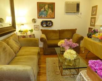 Sofa & loveseat, glass top brass base coffee table, lots of bric-a-brac, framed art, decorative wall hangings