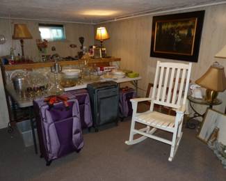 Loaded basement!! Bric-a-brac, kitchenware, luggage, white rocking chair, art, table, lamps