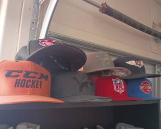 Vintage sports cap lot featuring NHL, NFL, NBA, and Detroit Lions themed hats