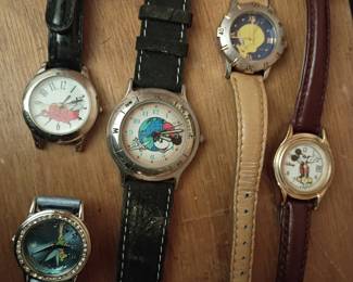 Collection of vintage character wristwatches featuring Mickey Mouse, Tweety Bird, and other cartoon favorites