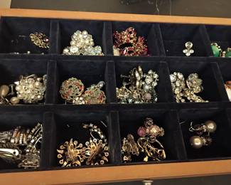 Beautiful assortment of vintage costume jewelry featuring rhinestone brooches, clip-on earrings, pearl accents, and colorful mid-century pieces