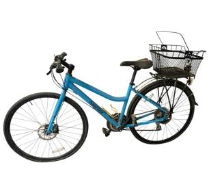 Nashbar blue stepthrough hybrid bicycle equipped with a rear basket