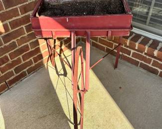 #017		Red Rustic “Fruit Pickers Cart” Garden Planter/Potting Cart w Large Metal Wheel Planter box 24” w x 12” d, Wheel 22.5” round, Overall height 28.5”	 $ 65.00 																						