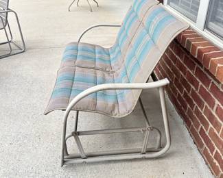 #008		Outdoor Glider Loveseat on Metal Frame w Blue/Beige Cushions. As is finish on frame. 45.5”L x 25”D x 34”H	 $ 65.00 																						