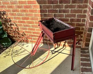 #017		Red Rustic “Fruit Pickers Cart” Garden Planter/Potting Cart w Large Metal Wheel Planter box 24” w x 12” d, Wheel 22.5” round, Overall height 28.5”	 $ 65.00 																						