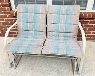 #008		Outdoor Glider Loveseat on Metal Frame w Blue/Beige Cushions. As is finish on frame. 45.5”L x 25”D x 34”H	 $ 65.00 																						