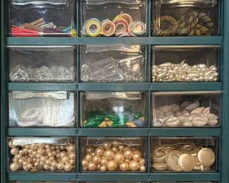 drawers filled with plastic and glass pendants and crafting components