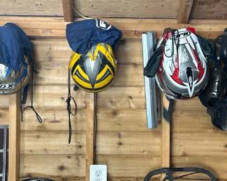 Several helmets and clothes for dirt bike racing