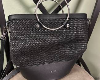 BCBG Andie black woven bucket bag featuring silver ring handles