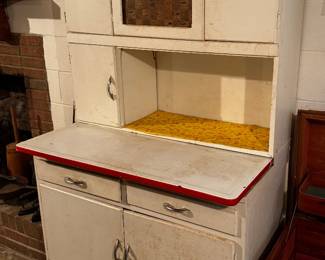 Hoosier cabinet with red and white enamelware