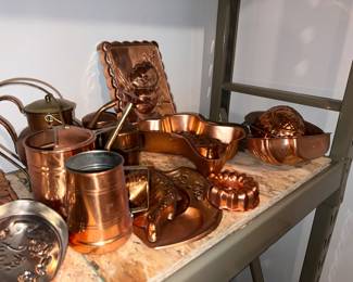 Assortment of vintage decorative and functional cooper kitchenware